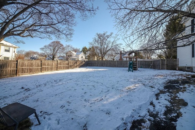 snowy yard with a playground