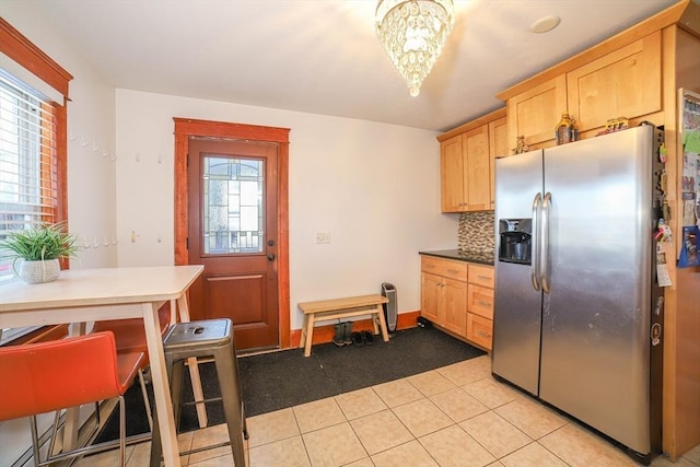 kitchen with plenty of natural light, light brown cabinetry, and stainless steel fridge with ice dispenser