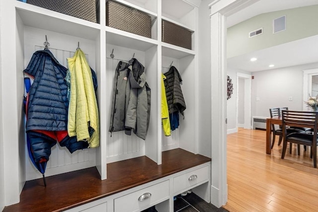 mudroom featuring recessed lighting, wood finished floors, visible vents, and radiator