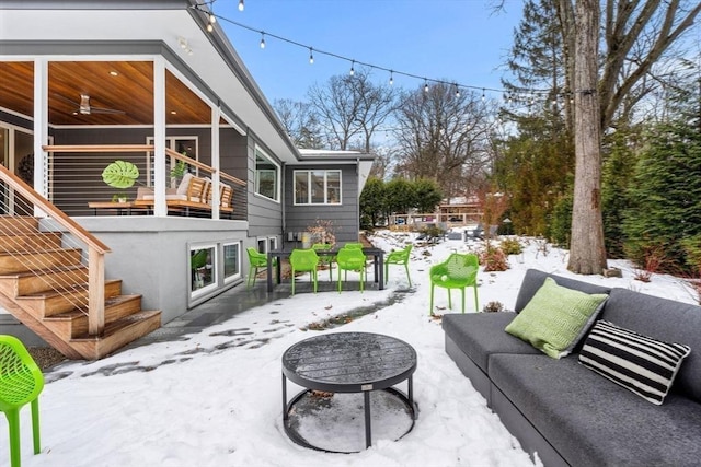 view of patio with stairs, outdoor lounge area, and a ceiling fan