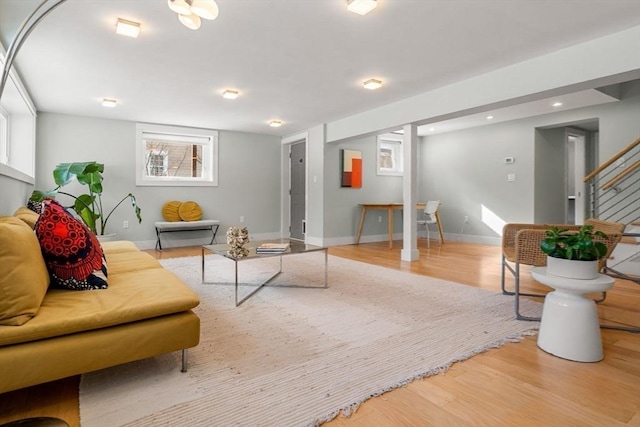 living area with stairs, recessed lighting, wood finished floors, and baseboards