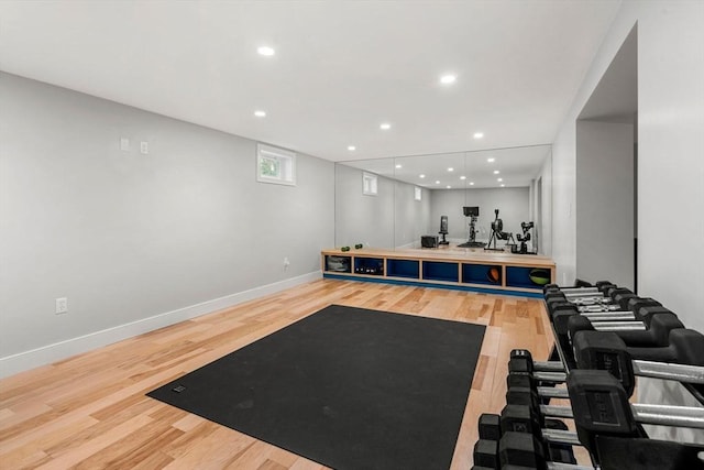 workout room with baseboards, wood finished floors, and recessed lighting