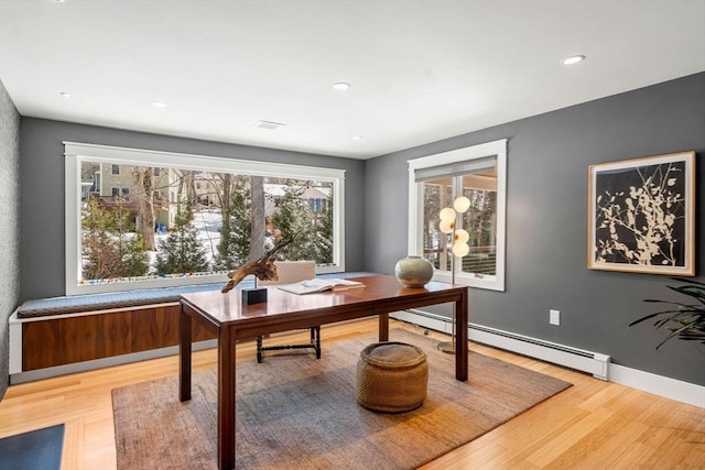 home office with light wood finished floors, baseboards, baseboard heating, and recessed lighting