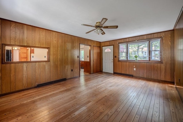 10 Primrose Rd, Billerica, MA 01821 - unfurnished living room with hardwood / wood-style floors, healthy amount of natural light, a baseboard heating unit, ceiling fan, and wooden walls