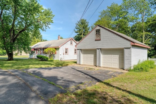 10 Primrose Rd, Billerica, MA 01821 - view of home's exterior with a detached garage, an outdoor structure, and a yard