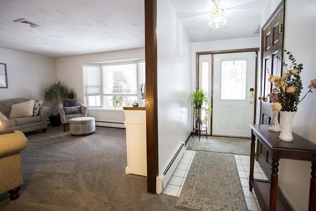 entrance foyer featuring a baseboard heating unit, light colored carpet, and visible vents