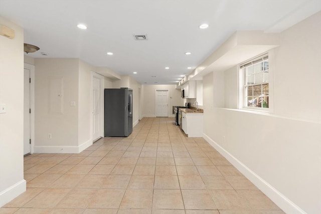 213-215 Florence St Unit 1, Boston, MA 02131 - kitchen with appliances with stainless steel finishes, white cabinets, recessed lighting, baseboards, and light tile patterned flooring