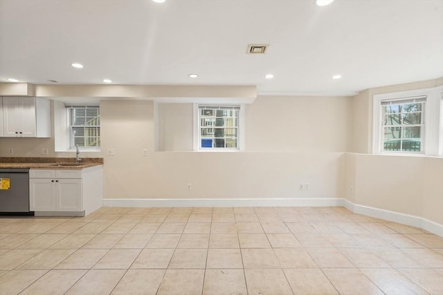 213-215 Florence St Unit 1, Boston, MA 02131 - kitchen featuring stainless steel dishwasher, recessed lighting, baseboards, a sink, and white cabinetry