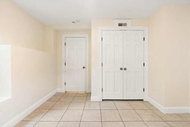 213-215 Florence St Unit 1, Boston, MA 02131 - unfurnished bedroom with light tile patterned floors, a closet, and baseboards