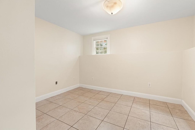 213-215 Florence St Unit 1, Boston, MA 02131 - empty room with light tile patterned floors and baseboards