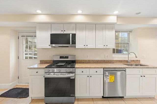 213-215 Florence St Unit 1, Boston, MA 02131 - kitchen featuring stainless steel appliances, a sink, white cabinetry, light stone counters, and recessed lighting