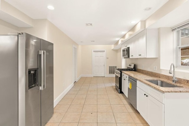 213-215 Florence St Unit 1, Boston, MA 02131 - kitchen with stainless steel appliances, a sink, white cabinetry, light stone counters, and recessed lighting