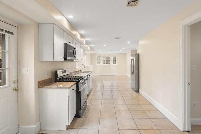 213-215 Florence St Unit 1, Boston, MA 02131 - kitchen featuring stainless steel appliances, white cabinetry, baseboards, a sink, and recessed lighting