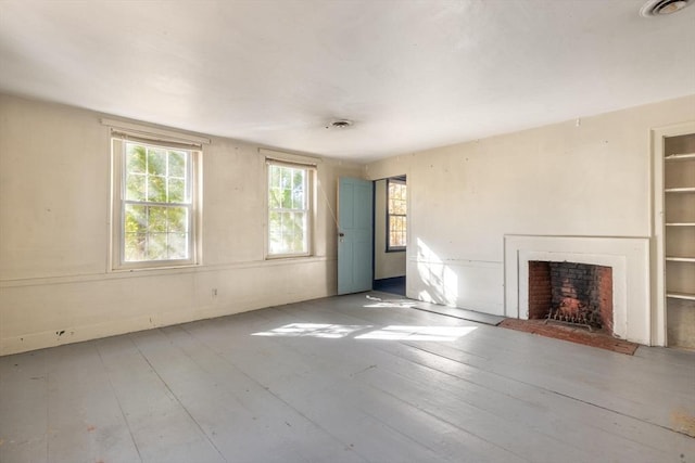 490 Plymouth, Bridgewater, MA 02324 - unfurnished living room with healthy amount of natural light, a fireplace with flush hearth, and light wood-style floors