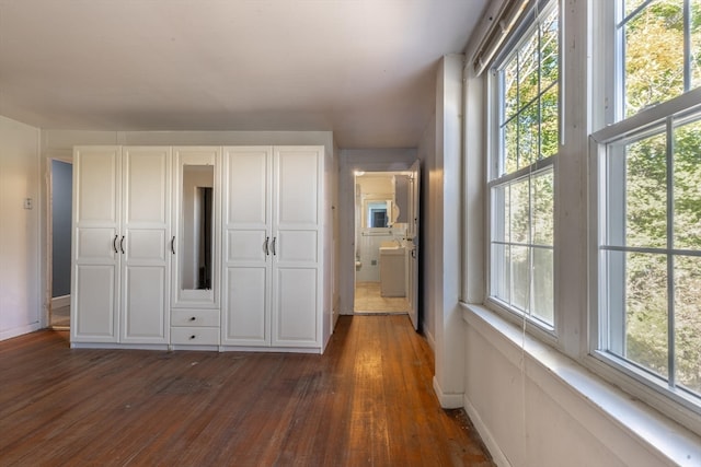 unfurnished bedroom with dark hardwood / wood-style flooring