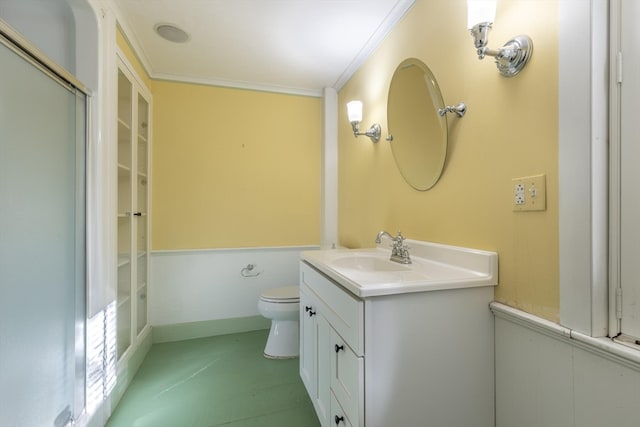 bathroom featuring vanity, ornamental molding, and toilet