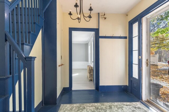 490 Plymouth, Bridgewater, MA 02324 - foyer entrance with a chandelier, radiator, and stairs