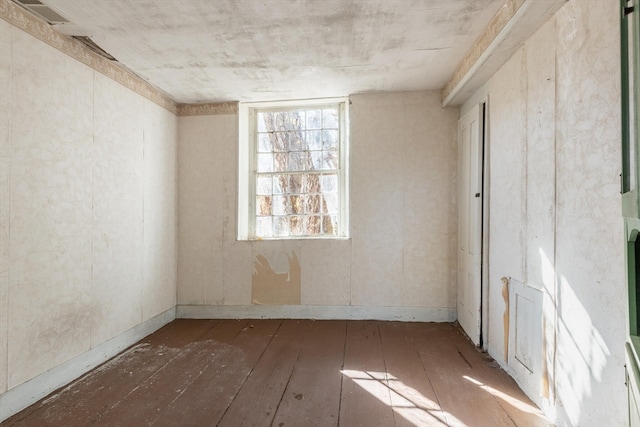 unfurnished room with wood-type flooring