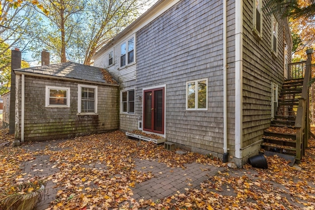 rear view of house featuring a deck and a patio area