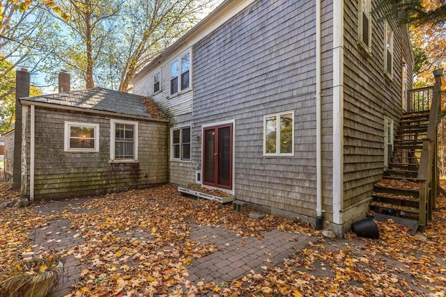 490 Plymouth, Bridgewater, MA 02324 - back of house with stairs, a chimney, and a patio