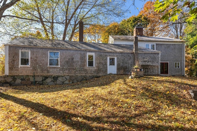 rear view of house with a yard