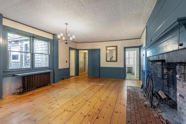 490 Plymouth, Bridgewater, MA 02324 - unfurnished living room with radiator heating unit, a chandelier, a textured ceiling, and a fireplace