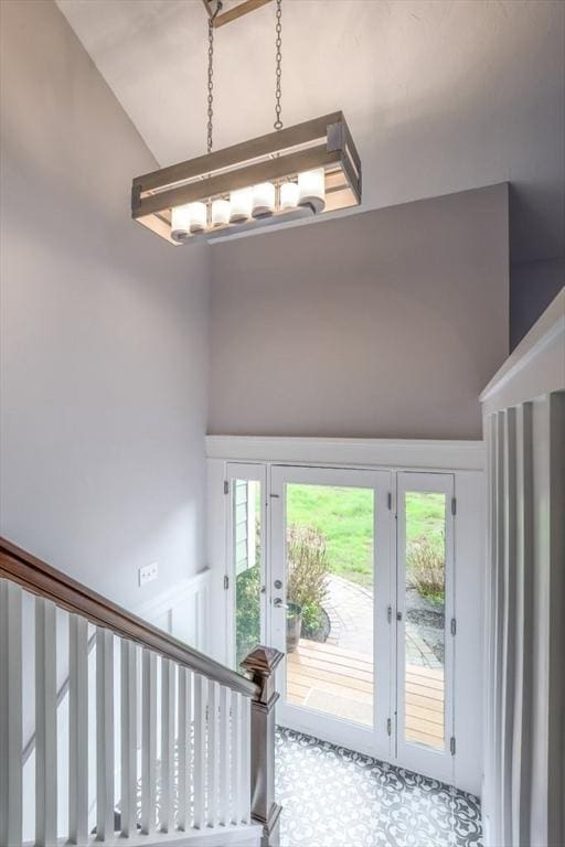 foyer featuring a chandelier and high vaulted ceiling