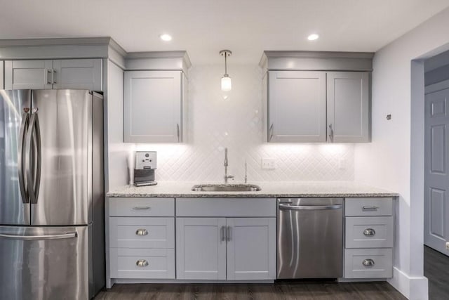 kitchen with stainless steel appliances, a sink, gray cabinets, dark wood-style floors, and recessed lighting