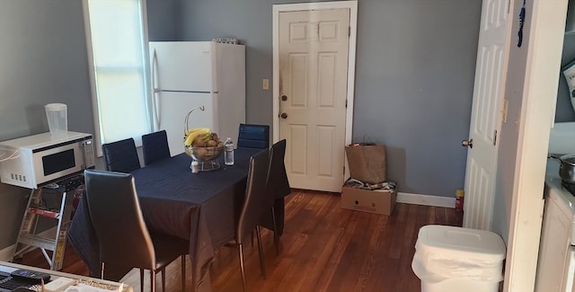 dining area with dark wood-type flooring