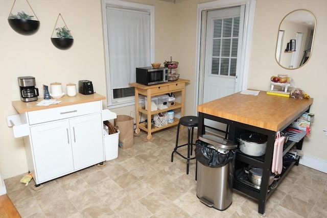 287 W 5th St, Boston, MA 02127 - kitchen with stainless steel microwave, white cabinets, and light countertops