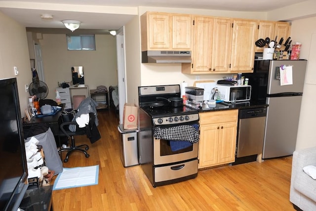 287 W 5th St, Boston, MA 02127 - kitchen with under cabinet range hood, appliances with stainless steel finishes, light brown cabinets, light wood-type flooring, and dark countertops