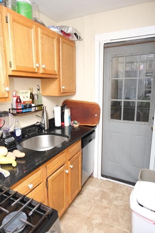 287 W 5th St, Boston, MA 02127 - kitchen featuring dishwasher, a sink, and dark stone counters