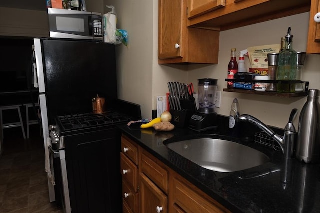 287 W 5th St, Boston, MA 02127 - kitchen featuring range with gas cooktop, a sink, and brown cabinetry