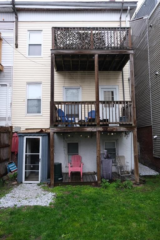 287 W 5th St, Boston, MA 02127 - rear view of house featuring a balcony and a lawn