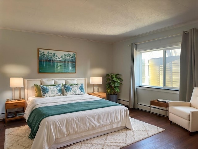 bedroom featuring dark hardwood / wood-style flooring, baseboard heating, and crown molding