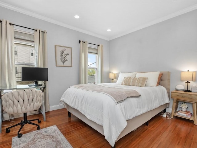 bedroom featuring ornamental molding, a desk, baseboards, wood finished floors, and recessed lighting