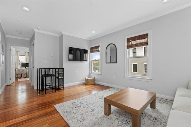 living room with ornamental molding, baseboards, wood finished floors, and recessed lighting