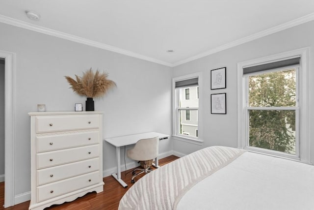 bedroom featuring dark wood-style floors, baseboards, and crown molding