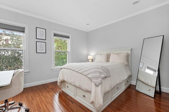 bedroom featuring wood finished floors, ornamental molding, and baseboards