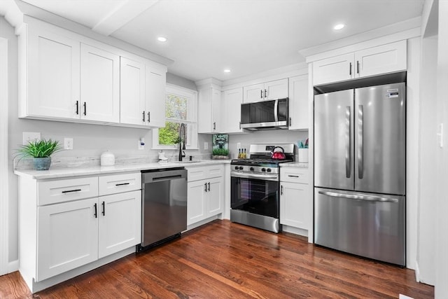 kitchen with stainless steel appliances, recessed lighting, white cabinetry, and a sink