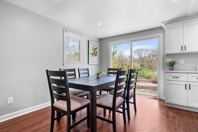 dining room with recessed lighting, baseboards, a textured ceiling, and dark wood-type flooring