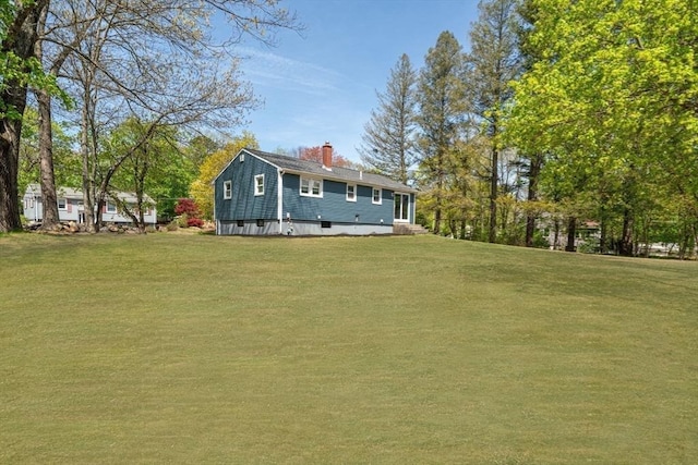 exterior space with a lawn and a chimney