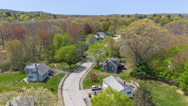 drone / aerial view featuring a view of trees