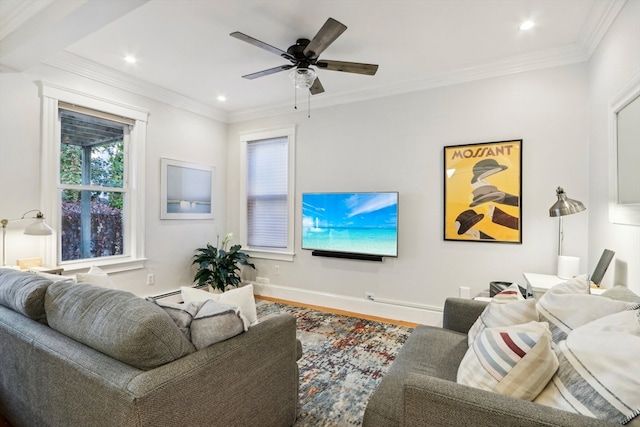 living room with hardwood / wood-style floors, baseboard heating, ceiling fan, and ornamental molding