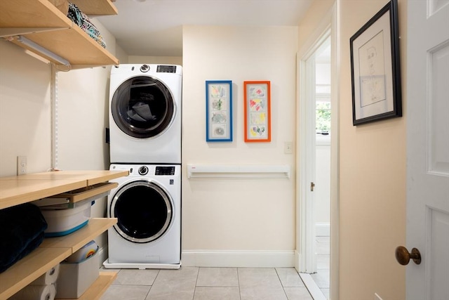 26 Sterling St, Newton, MA 02465 - laundry area with stacked washer / drying machine, baseboards, and light tile patterned floors