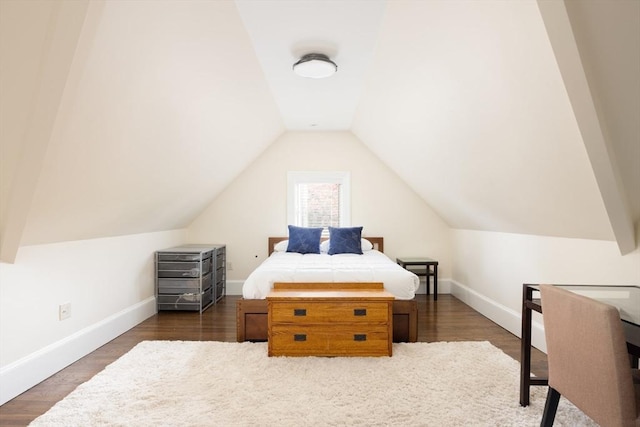 26 Sterling St, Newton, MA 02465 - bedroom with lofted ceiling, baseboards, and dark wood-style flooring