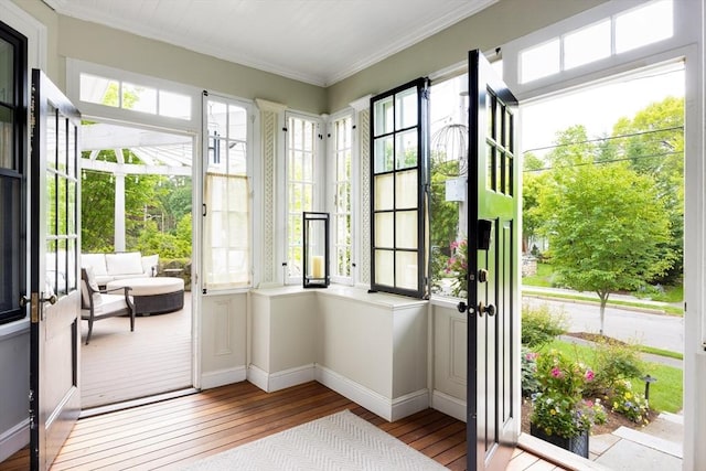 26 Sterling St, Newton, MA 02465 - entryway featuring wood-type flooring, ornamental molding, and baseboards