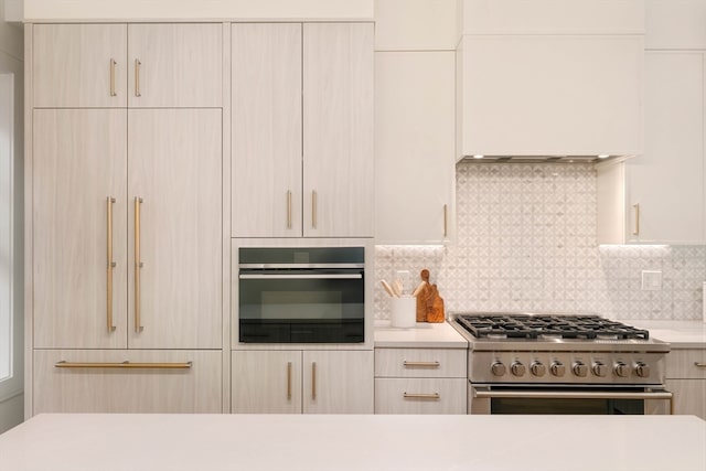 kitchen with stainless steel appliances, decorative backsplash, and light brown cabinets