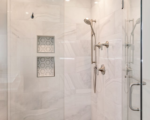 bathroom featuring a shower with door