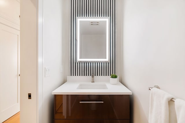 bathroom with vanity and wood-type flooring